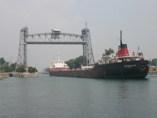 Ship passing under a lift bridge in the Welland Canal