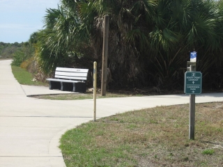 bench and a sign to the Caspersen Park